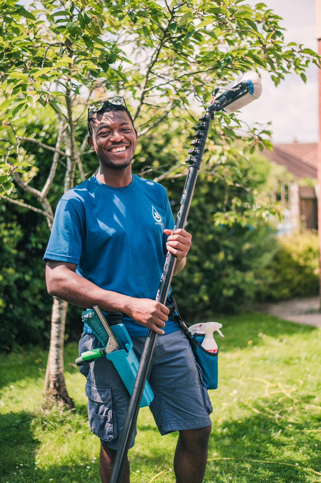 JE Window Cleaning team member with water-fed pole